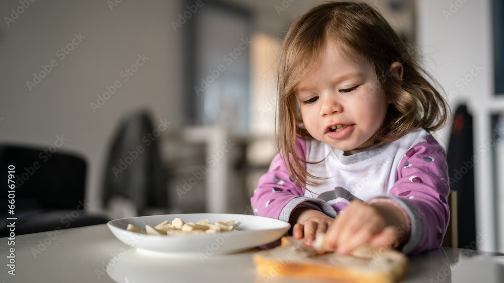 one girl small caucasian toddler female child eat at the table at home one girl small caucasian toddler female child eat at the table at home