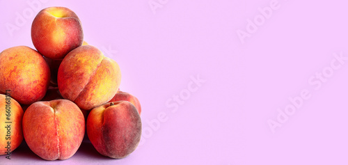 Heap of sweet peaches on lilac background with space for text photo