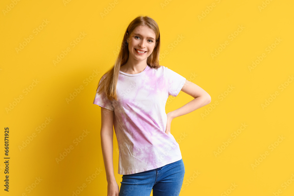 Young woman in tie-dye t-shirt on yellow background Young woman in tie-dye t-shirt on yellow background