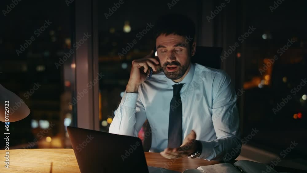 Busy worker speaking telephone at workplace late evening close up. Tired manager