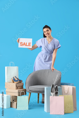 Smiling young woman holding...