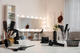Different hairdressing tools on table in beauty salon