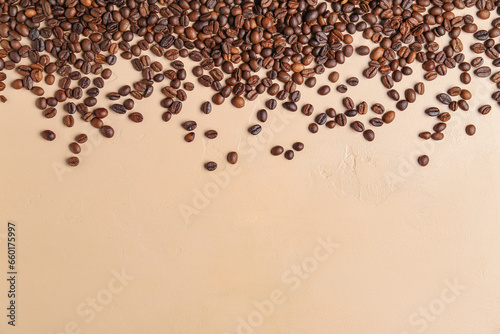 Scattered coffee beans on beige background