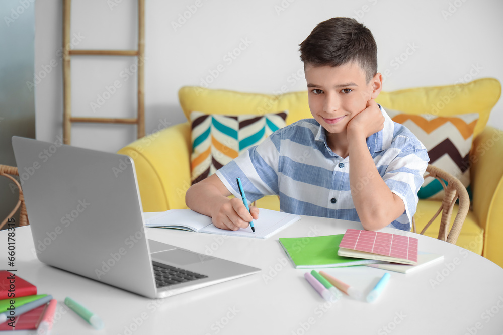 Little boy studying online with laptop at home Little boy studying online with laptop at home