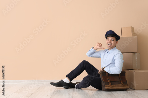 Young postman with bag and ...