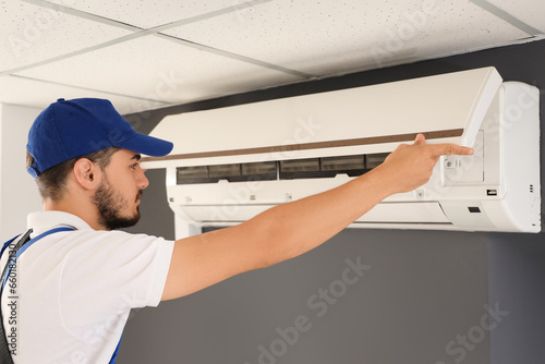 Male technician fixing air ...