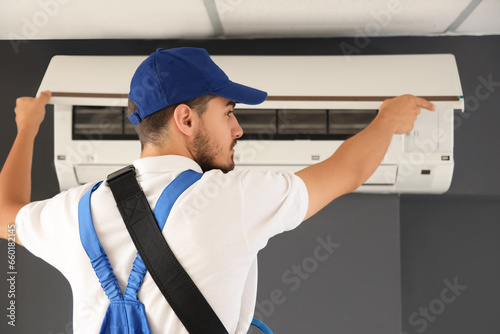 Male technician fixing air ...