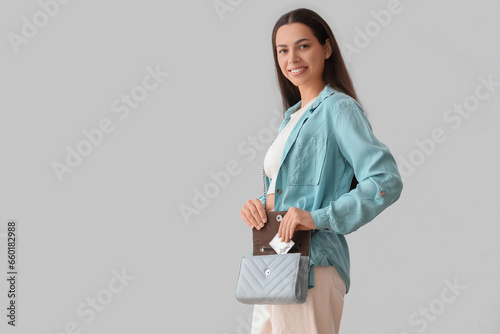 Young woman with condom in ...