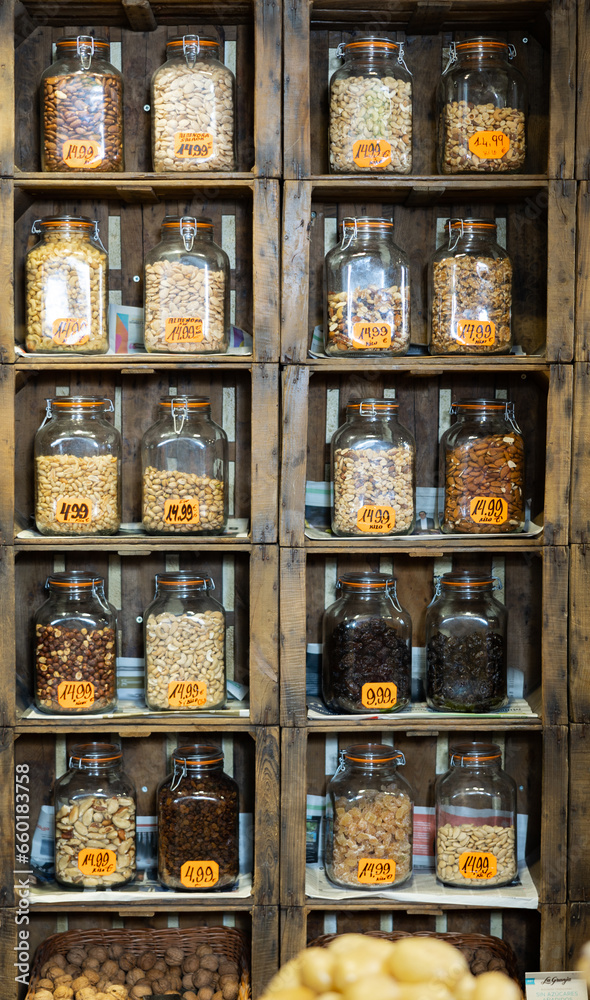 Nuts in jars laid out beautifully on shelves in merket