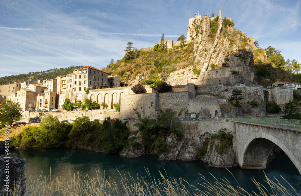 Panoramic view of old houses surrounded with greenery and maintains in Sisteron village, France