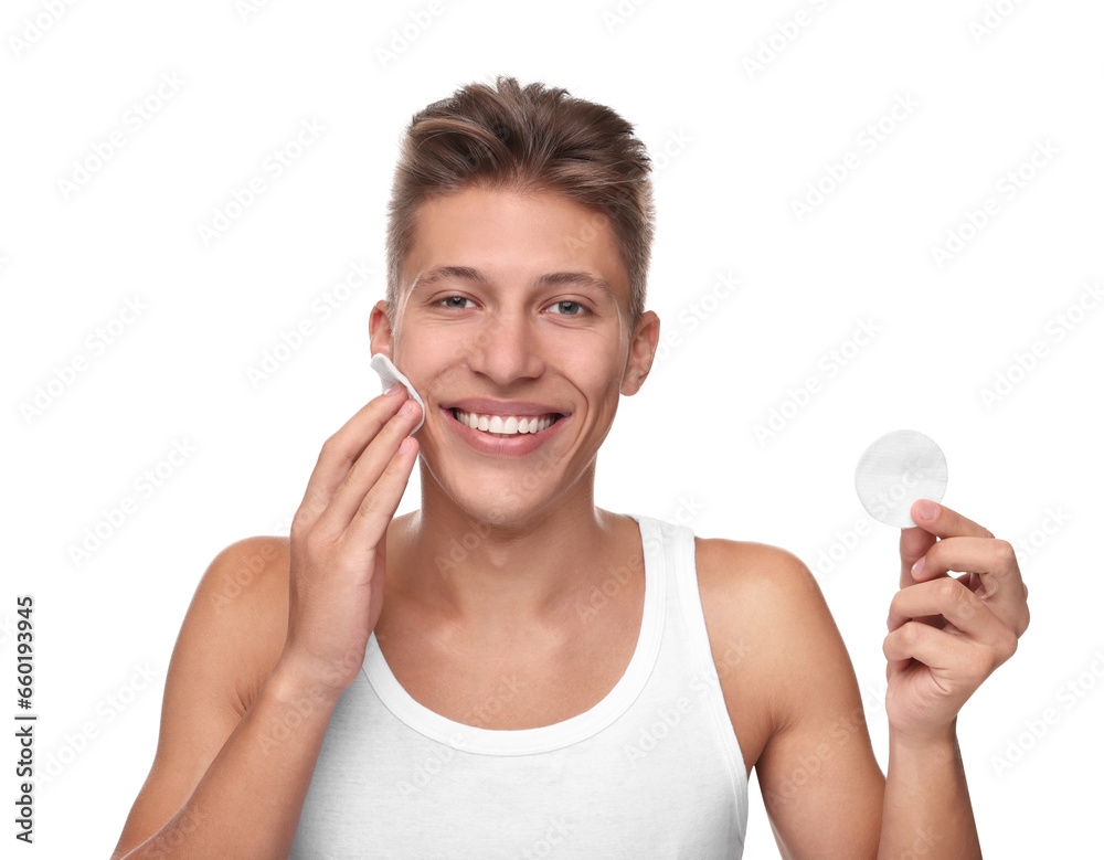 Handsome man cleaning face with cotton pad on white background Handsome man cleaning face with cotton pad on white background