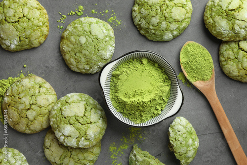 Tasty matcha cookies and powder on grey table, flat lay