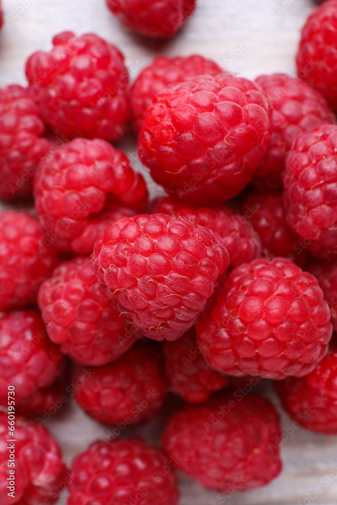 Tasty ripe raspberries on white table, top view Tasty ripe raspberries on white table, top view