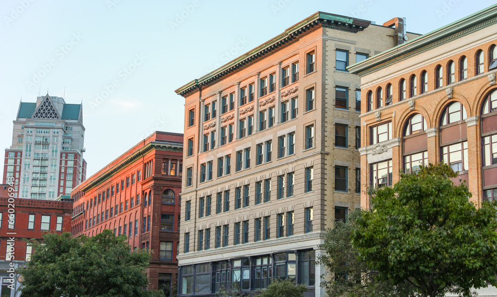 modern cityscape at dusk, featuring illuminated skyscrapers reflecting in calm waters, epitomizing urban progress and innovation