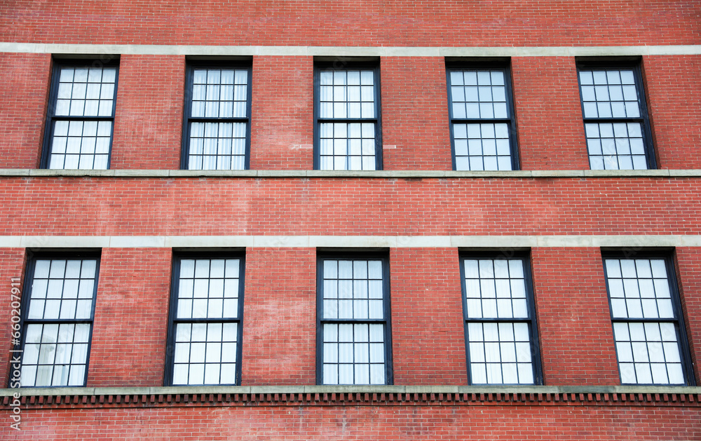  brick building, symbolizing strength and longevity in commercial real estate, stands tall against a clear blue sky, evoking stability and growth