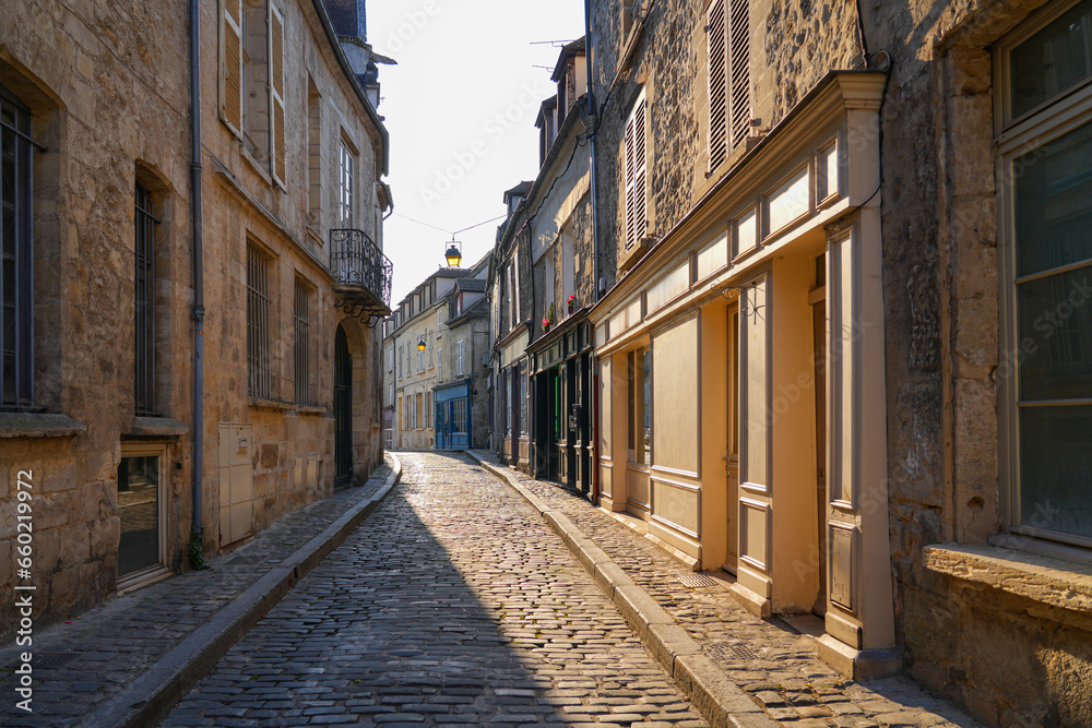 Narrow cobbled street of the medieval city center of Senlis in Oise, Picardy, France
