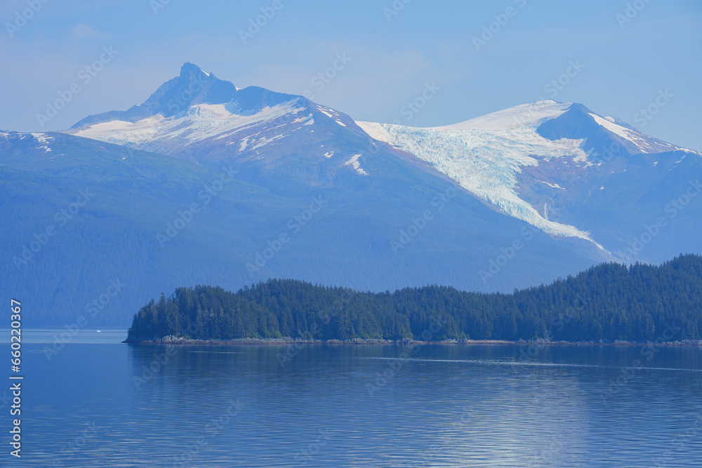 Hanging glacier towering above the coastal waters of the Inside Passage on a mountainous slope in Southeastern Alaska in the Pacific Ocean, USA