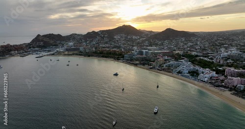 Beachfront Dawn Aerial Splendor of Cabo San Lucas Sunrise From Above Water Looking Towards the Harbor