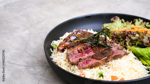 Tender New York Sliced Beef Served with Buttery Rice and Fresh Vegetables