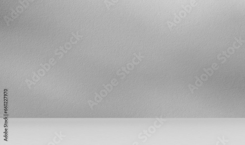 Empty gray room studio for product presentation with sunlight effect shadow on the wall and floor. Minimal grey room backdrop design concept. 