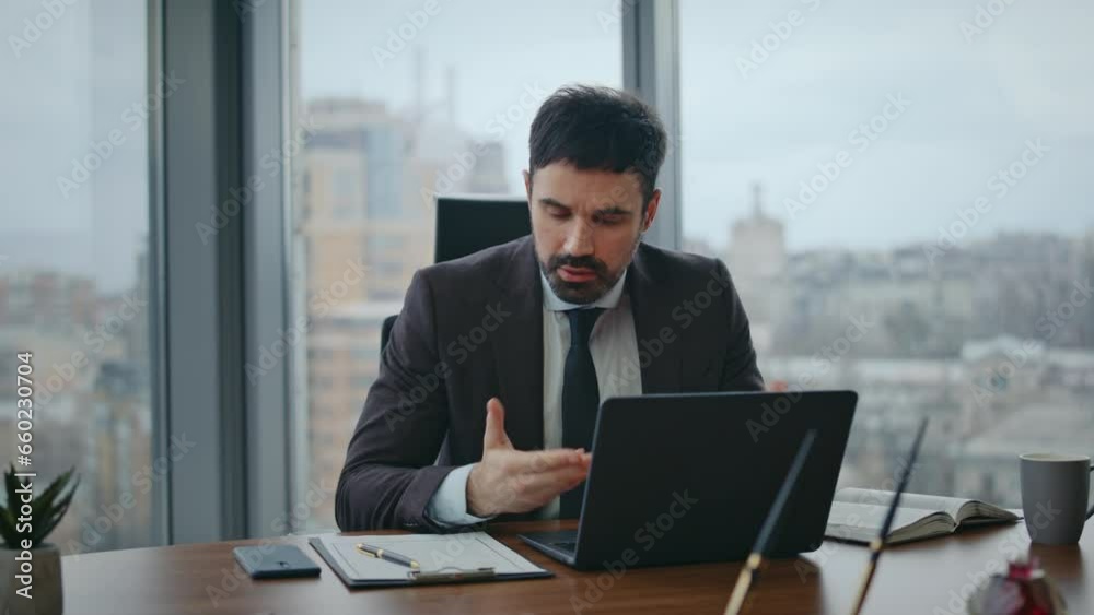 Nervous boss talking video meeting sitting office closeup. Manager videocalling Nervous boss talking video meeting sitting office closeup. Manager videocalling