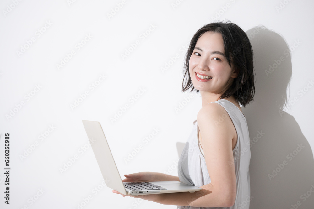 Young student-like woman studying typing using a computer, looking at the camera. Young student-like woman studying typing using a computer, looking at the camera.
