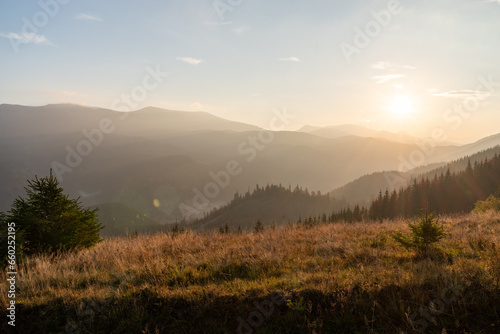 Morning landscape in the mountains. Warm morning sun in the mountains. Dawn in the mountains. Beautiful warm landscape. © vzwer