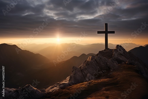 A cross standing on top of the mountain at Sunrise, religious concept background. 