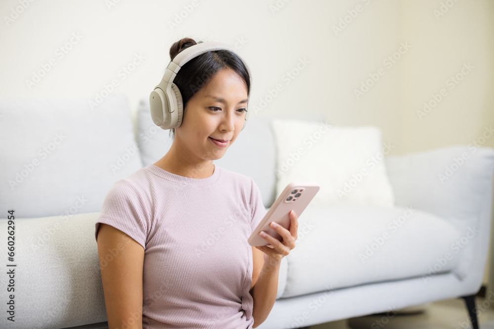 Woman wear headphone and use of mobile phone Woman wear headphone and use of mobile phone