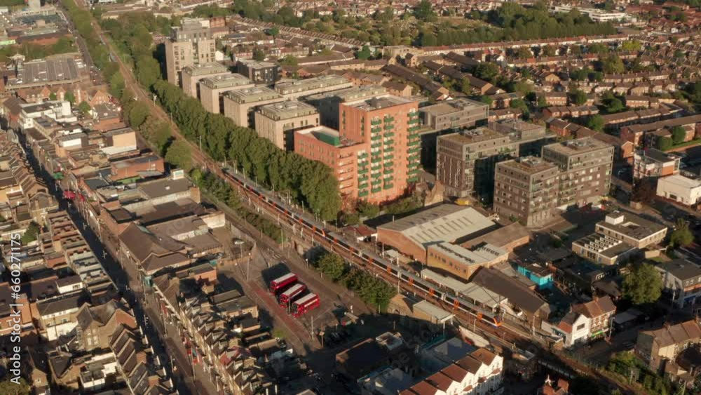 Rising aerial shot of London Overground train arriving at st James street station Walthamstow Rising aerial shot of London Overground train arriving at st James street station Walthamstow