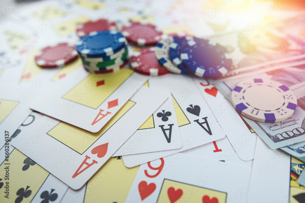 Gambling concept with money dollar bills, poker cards and chips on table Gambling concept with money dollar bills, poker cards and chips on table