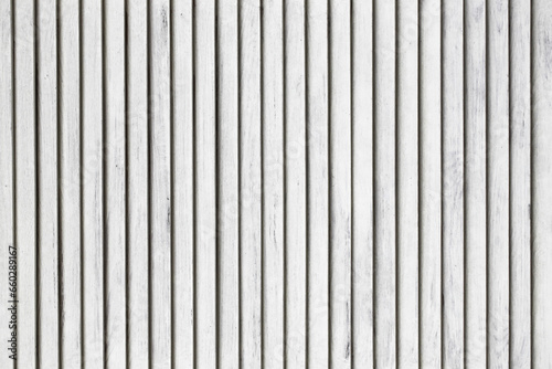 Vertical stripes texture. White wood background. Lines pattern. White paint wooden panel. Closeup window shutter. Vintage architecture pattern.