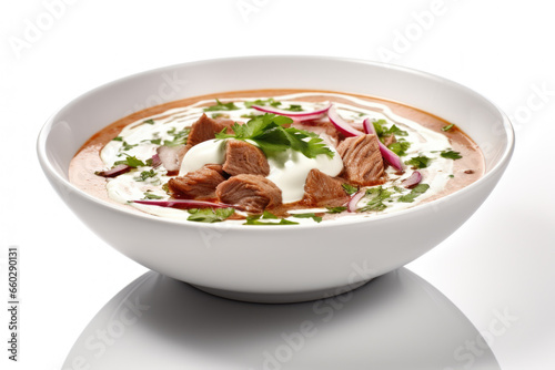 Delicious bowl of soup with tender meat and dollop of creamy sour cream. Perfect for warming up on cold day. Can be used in recipes or food-related articles.