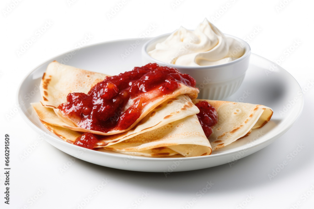 White plate topped with crepes and accompanied by bowl of whipped cream. This delicious dessert is perfect for any occasion.