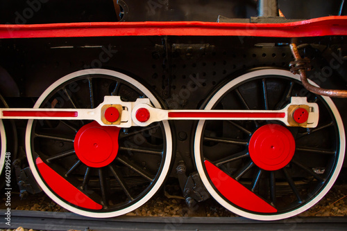 Old style red and white colored steam locomotive wheel. photo