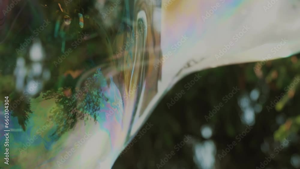 Soap bubbles floating in the air. close-up. slow motion. Radiant big soap bubble flying in the air. sunny summer day. 