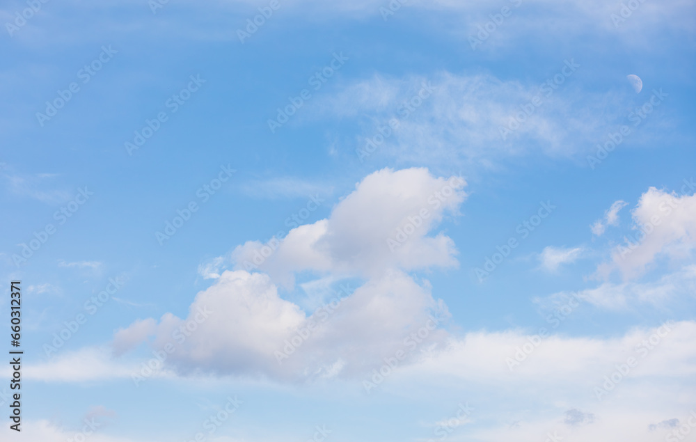 Late afternoon, the moon floating in the blue sky. Late afternoon, the moon floating in the blue sky.