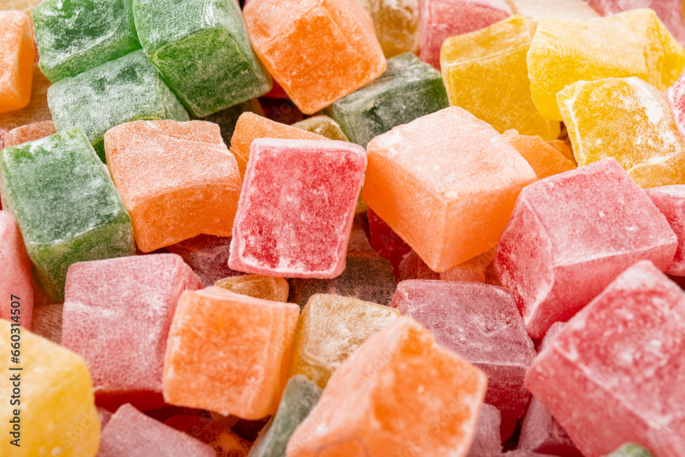 Closeup of multicolored cubes Turkish delight (Lokum). Selective Focus. Flat lay.
