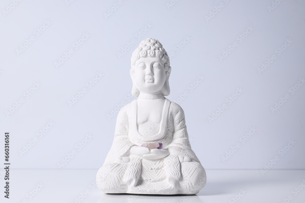 Buddha statue and stones on white background Buddha statue and stones on white background