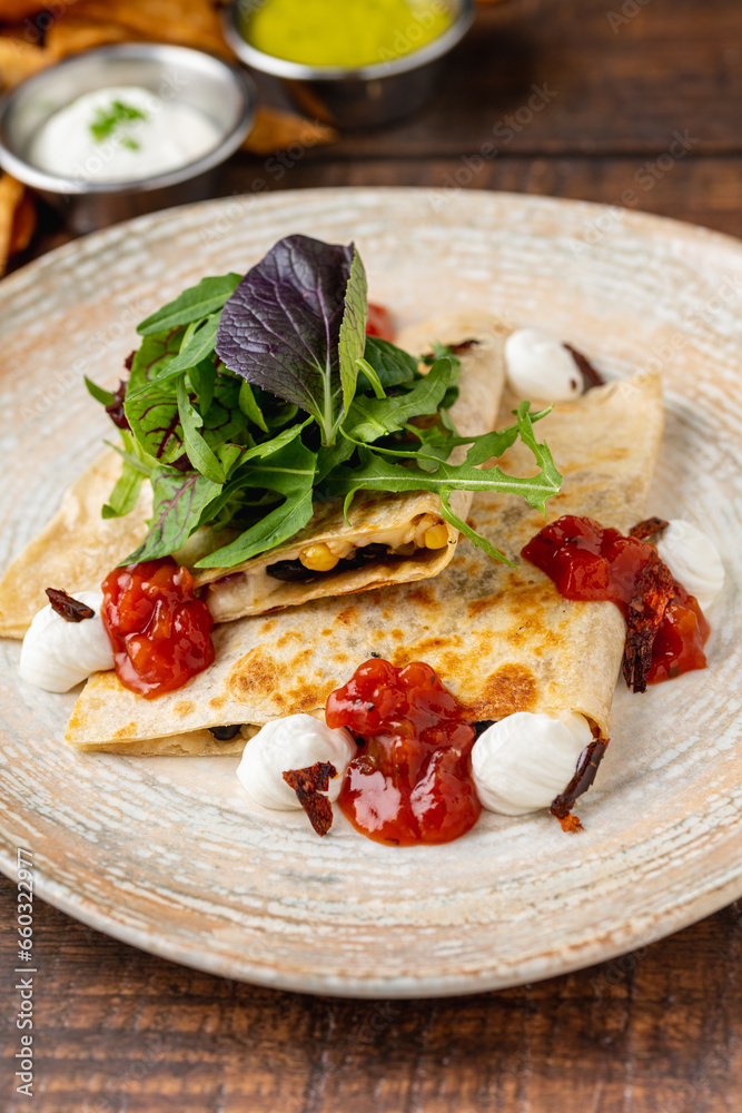 Mexican food molotes with sauces on wooden table Mexican food molotes with sauces on wooden table