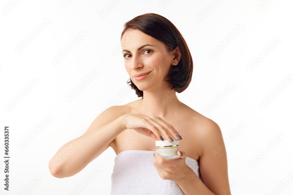 Cheerful beautiful young model, woman with bare shoulders showing, advertising eye cream over white background. Close Up Cheerful beautiful young model, woman with bare shoulders showing, advertising eye cream over white background. Close Up