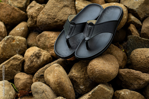 Billede på lærred Black leather sandals, pictured outdoors