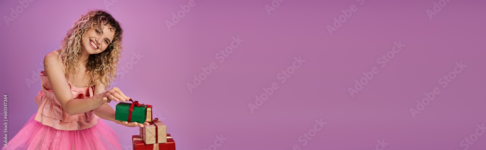 happy woman in tooth fairy costume holding one of presents and smiling cheerfully at camera, banner happy woman in tooth fairy costume holding one of presents and smiling cheerfully at camera, banner