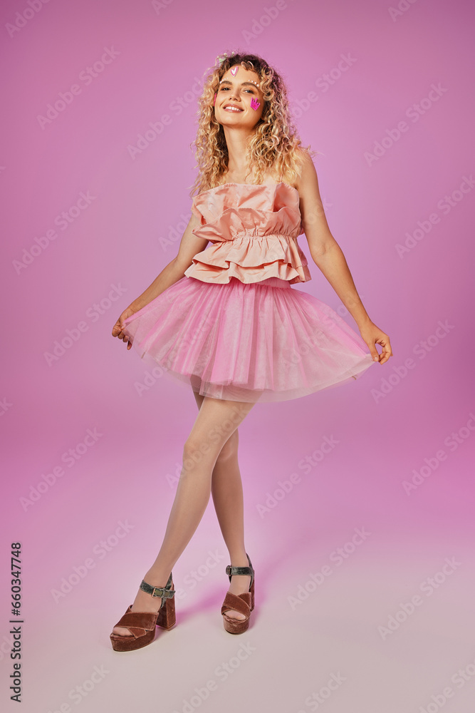 gorgeous lovely woman in pink tooth fairy costume with face stickers posing on pink backdrop gorgeous lovely woman in pink tooth fairy costume with face stickers posing on pink backdrop