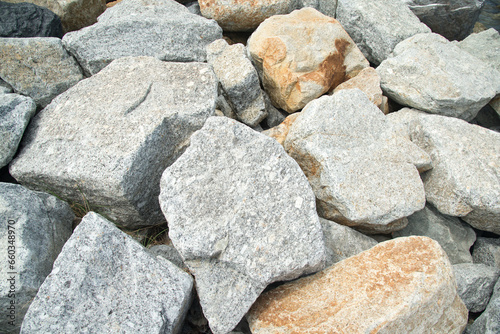 Close up of a pile of large crushed granite stones, to sell as building material and Waterproof line