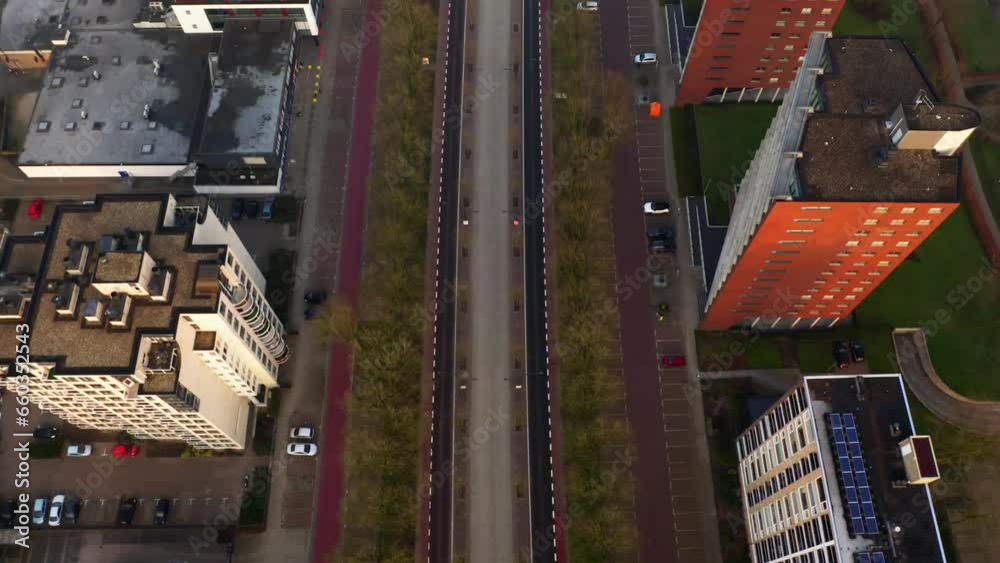 Dutch buildings and neighborhoods during sunrise in the mist, shot by drone. Dutch buildings and neighborhoods during sunrise in the mist, shot by drone.