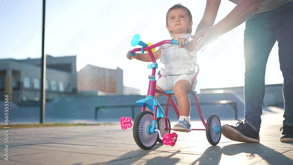 father teaches son baby to ride a children bike. happy family kid dream ...