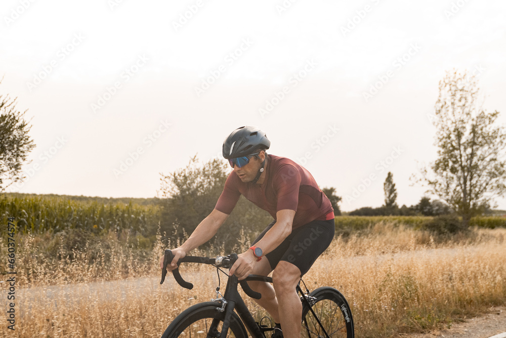 Detail shot of the legs of a cyclist riding a bike in the countryside. Detail shot of the legs of a cyclist riding a bike in the countryside.