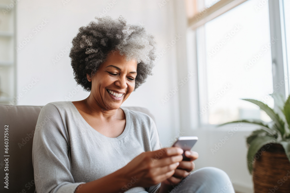 Portrait of a relaxed senior woman laughing while using her smartphone at home. Modern lifestyle of the elderly people. Portrait of a relaxed senior woman laughing while using her smartphone at home. Modern lifestyle of the elderly people.