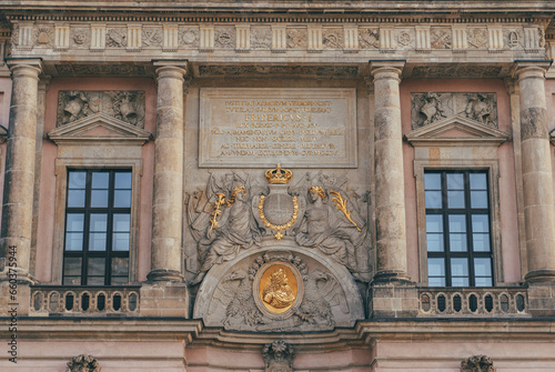 detail view of important building with gold elements decorated in german style and two simmetrical columns  photo